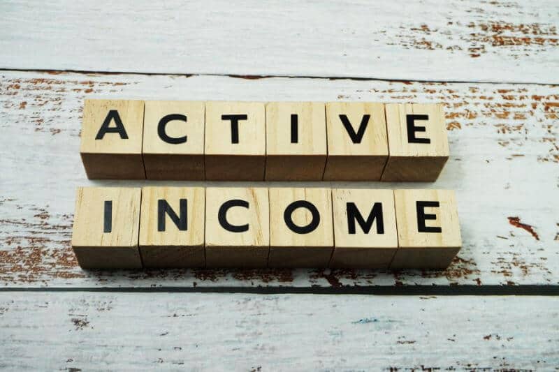 wooden blocks that spell out the words "active income"